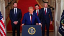 President Trump stands at a podium at the White House next to other top officials, including Vice President JD Vance.