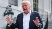 Donald Trump talks to reporters in front of the White House with his hands up and his mouth open