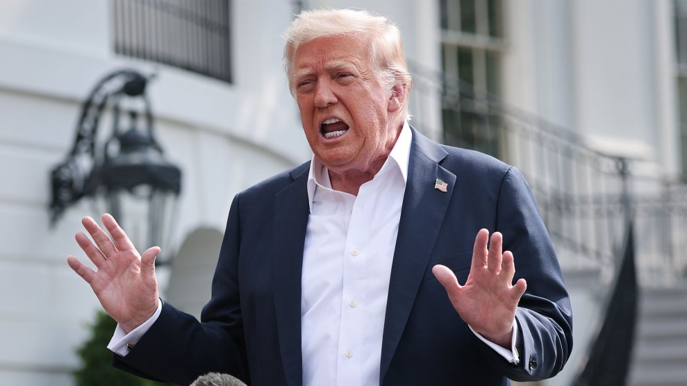 Donald Trump talks to reporters in front of the White House with his hands up and his mouth open