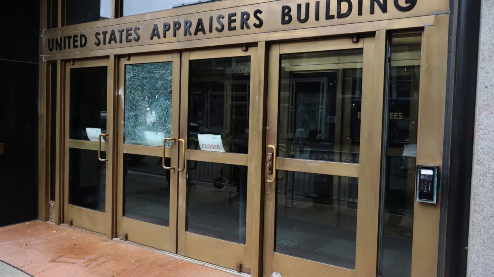 A large, set of building doors, framed in tarnished brass, with the words Federal Appraisers Building etched into the door header.