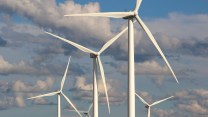 Wind turbines against a cloudy sky.