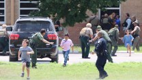Three children run out of a school building. Several law enforcement officers in various uniforms stand outside, waving at the children to keep running.
