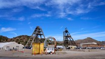 Two mine shafts in front of small mountains.