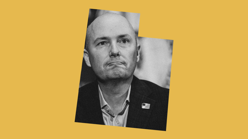 A photo of a bald, middle-aged Caucasian man in a suit jacket and open-collar shirt within the shape of the state of Utah. The shape is set against a yellow background.