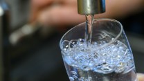 A close up image of a glass being filled with tap water