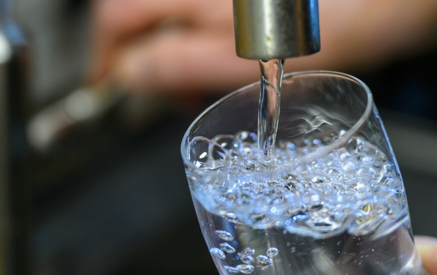 A close up image of a glass being filled with tap water