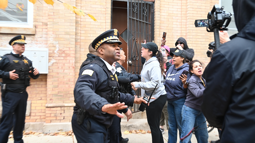 Law enforcement confronts crowd after ICE raid.