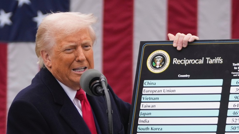 Trump holds up a poster labeled "Reciprocal Tariffs" showing the names of countries targeted with new import taxes and his proposed rates.