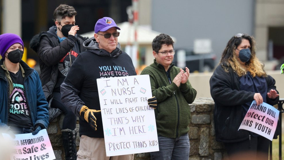A demonstrator protesting the President Donald Trump's anti-trans executive orders holds up a sign that reads "I am a nurse. I will fight for the lives of children. That's why I'm here. Protect trans kids."