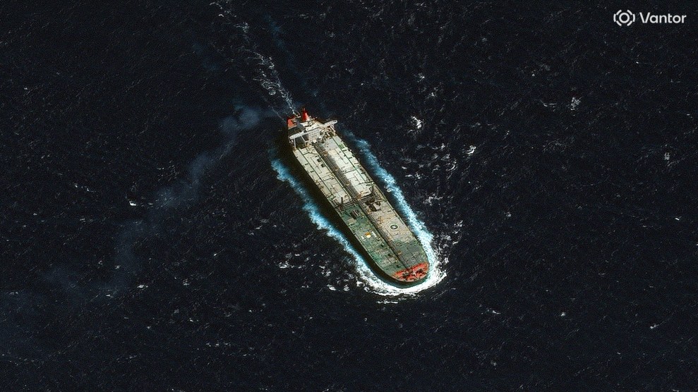 A satellite image from a bird's-eye view of an oil tanker traveling in the ocean.