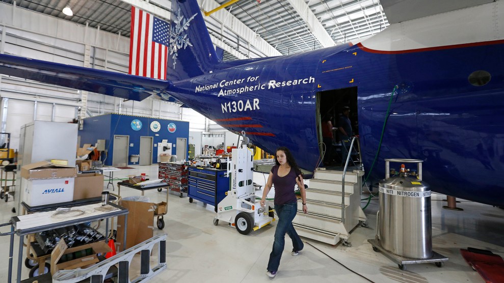 A person walks out of a plan with "National Center for Atmospheric Research" emblazoned on it.