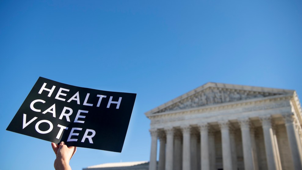 Someone holding up a sign that says "Health Care Voter" in front of a white building in DC.
