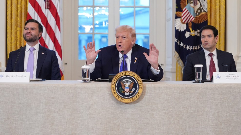 From left to right: JD Vance, Donald Trump, and Marco Rubio sit at a table. They are all wearing suits. In front of Trump is a sign that says Seal of the President of the United States."