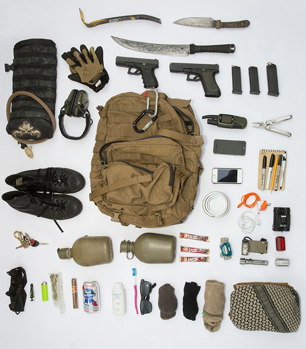 MM's bag contains several weapons and tools, three pairs of socks, waterproof paper and pens, an extra phone, marijuana, a beer, and a cigar.